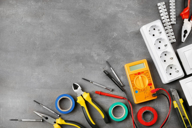 Different electrical tools on grey background